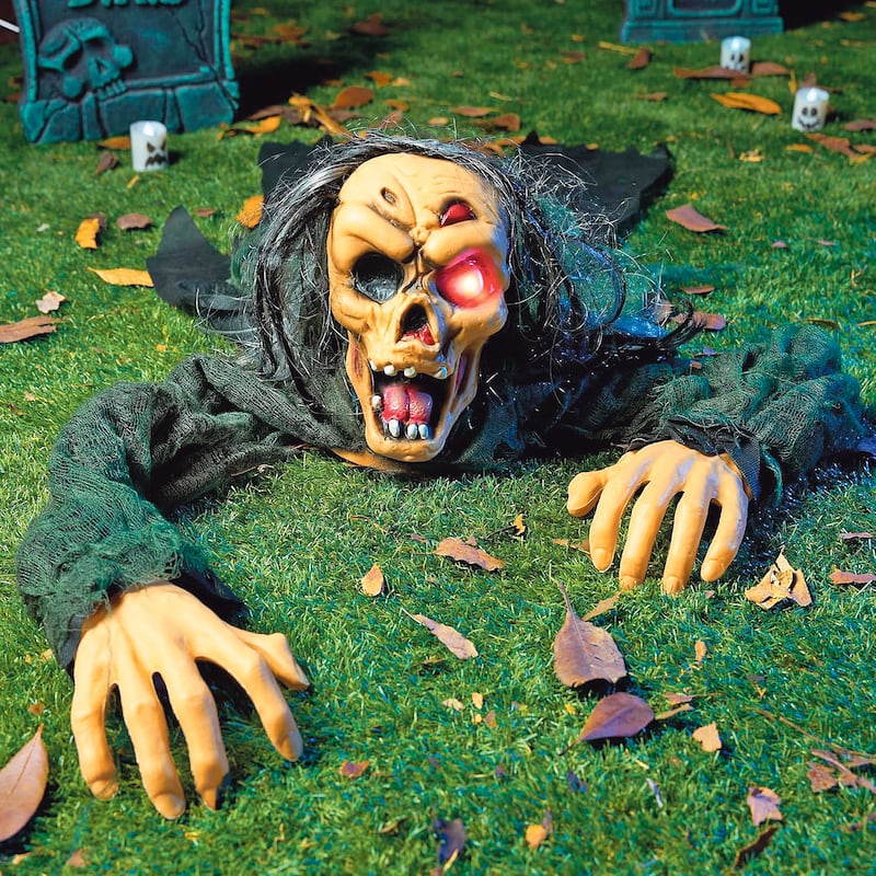 Zombi trepador. Decoración de Halloween sobre grama